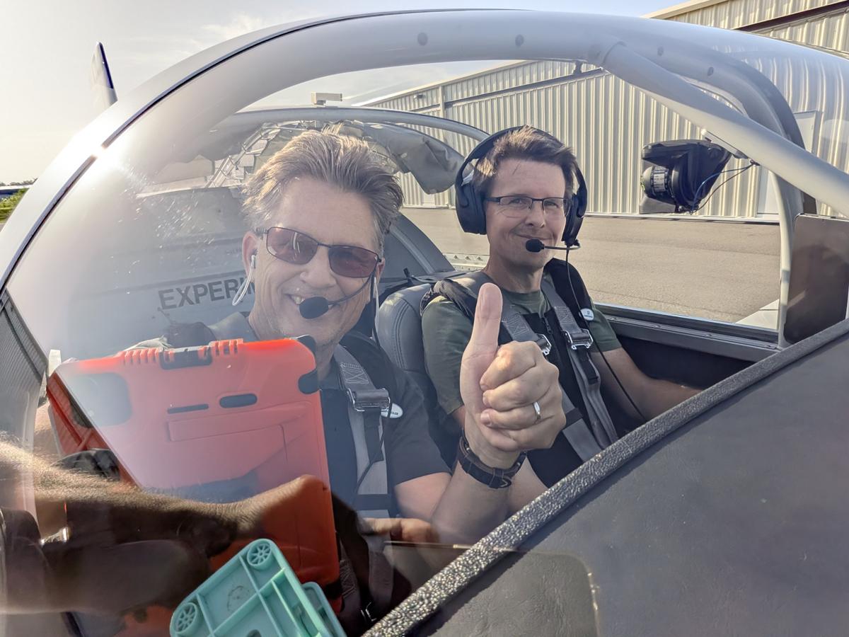 Russell in the cockpit with a student