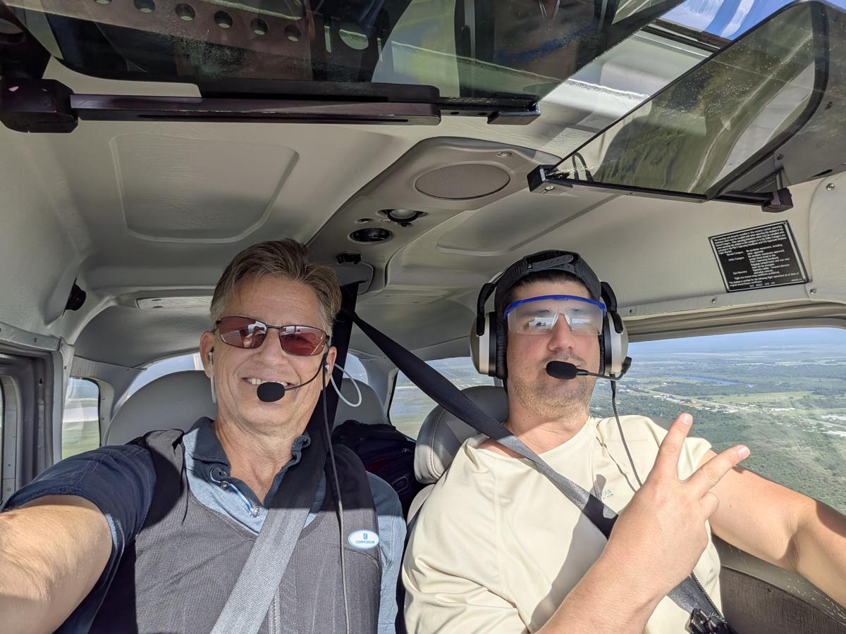 Russell in the cockpit with a student