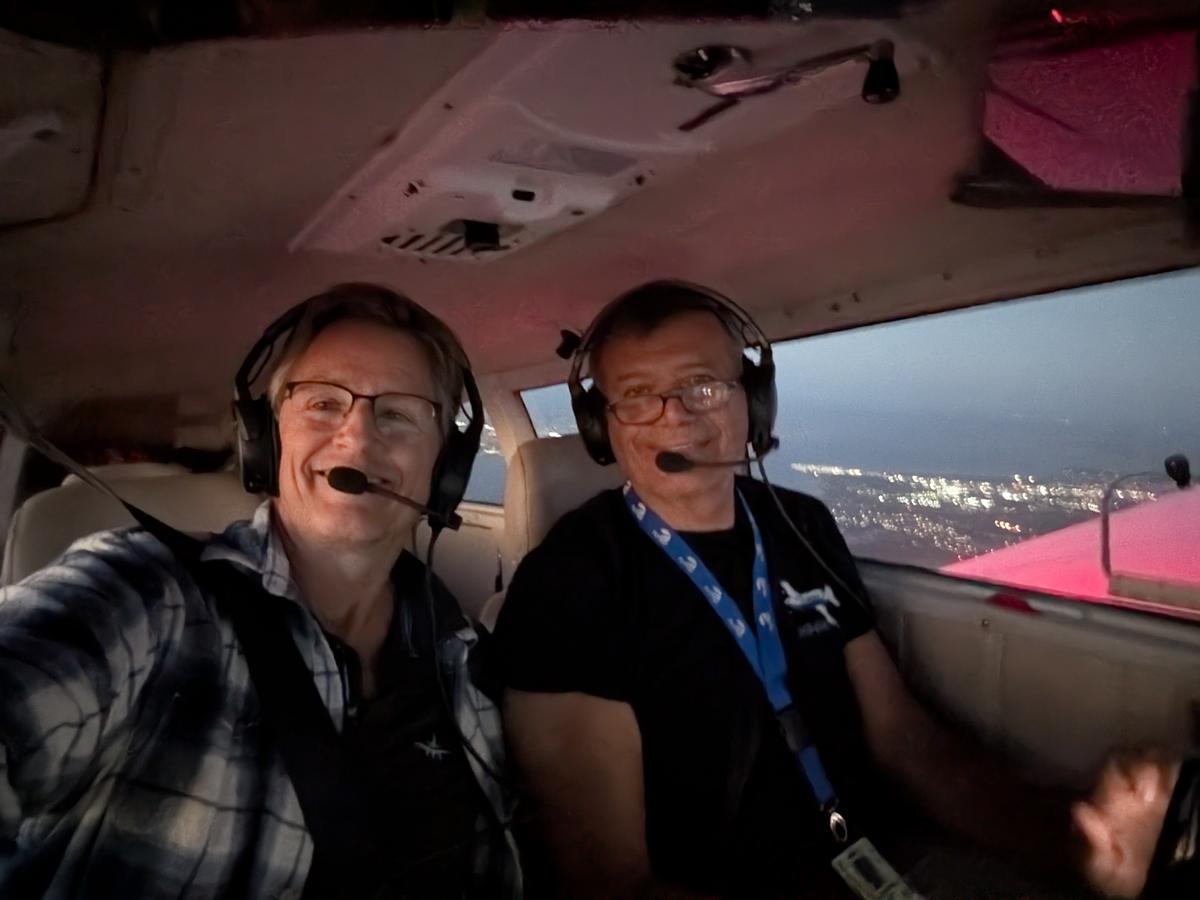 Russell in the cockpit with a student