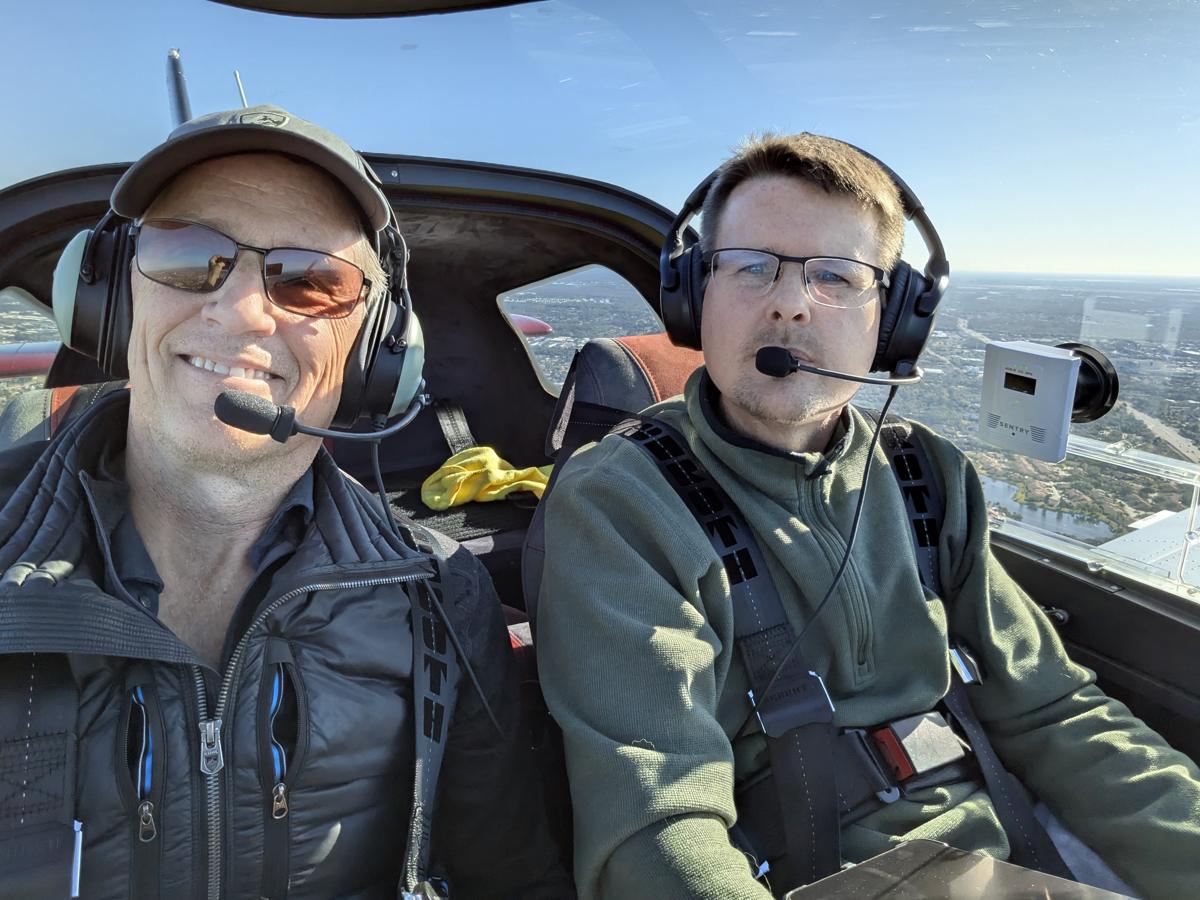 Russell in the cockpit with a student