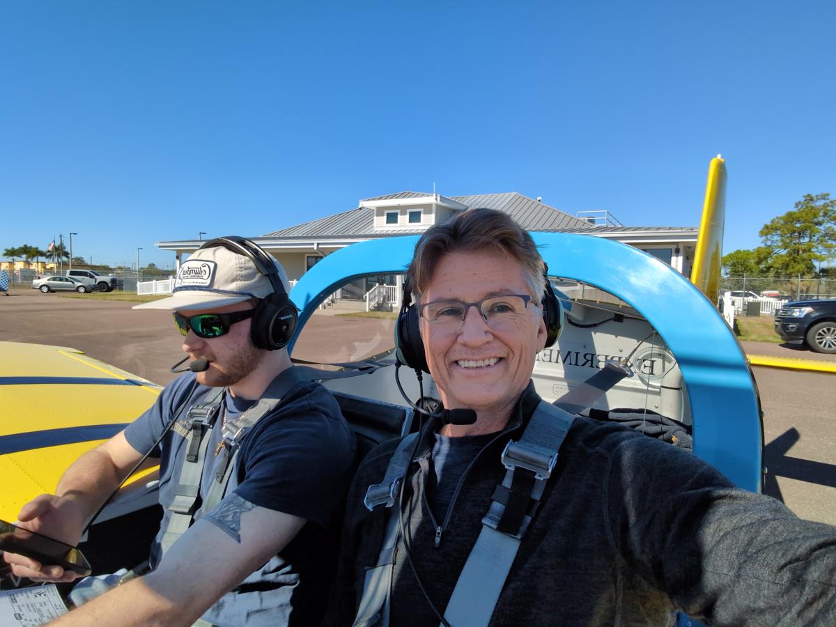 Russell in the cockpit with a student