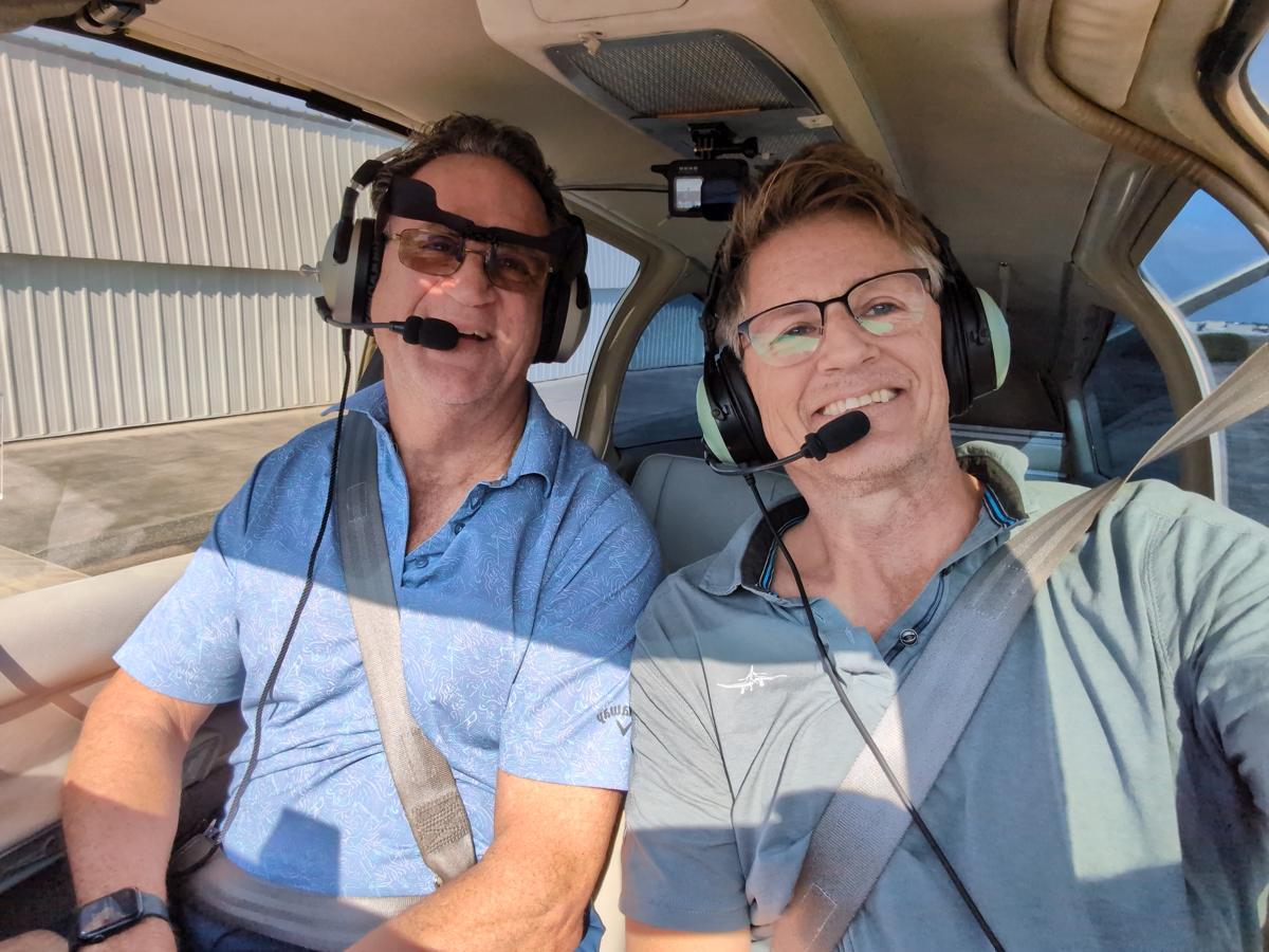 Russell in the cockpit with a student