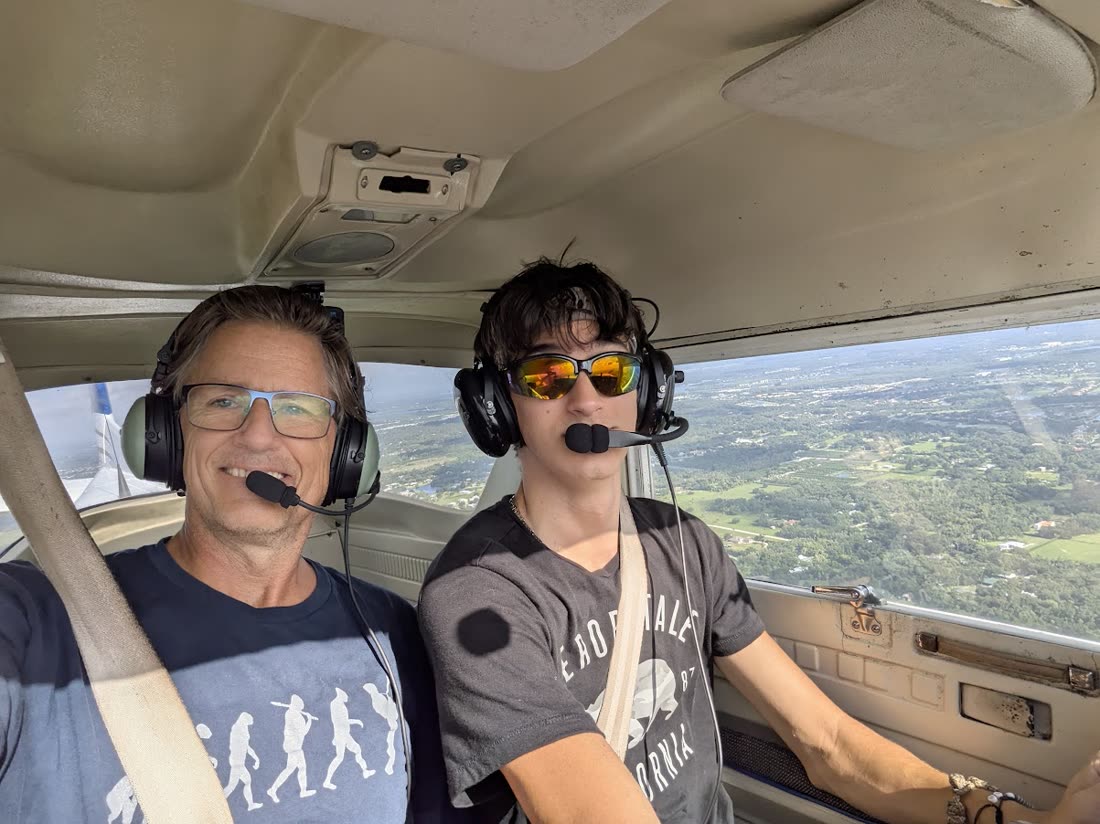 Russell in the cockpit with a student