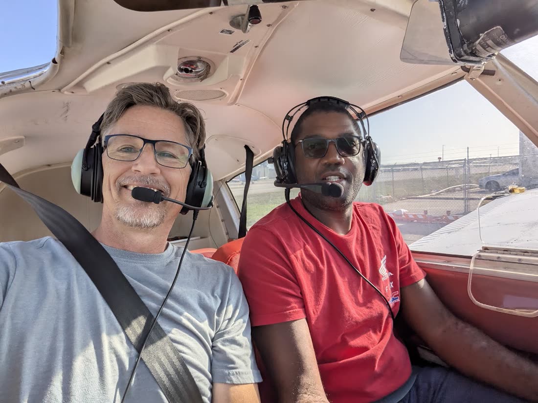 Russell in the cockpit with a student